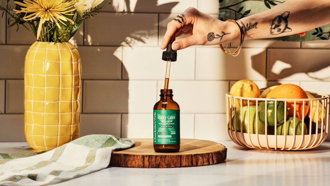 An image of Charlottes Web Daily Care CBD Oil on a wood plate