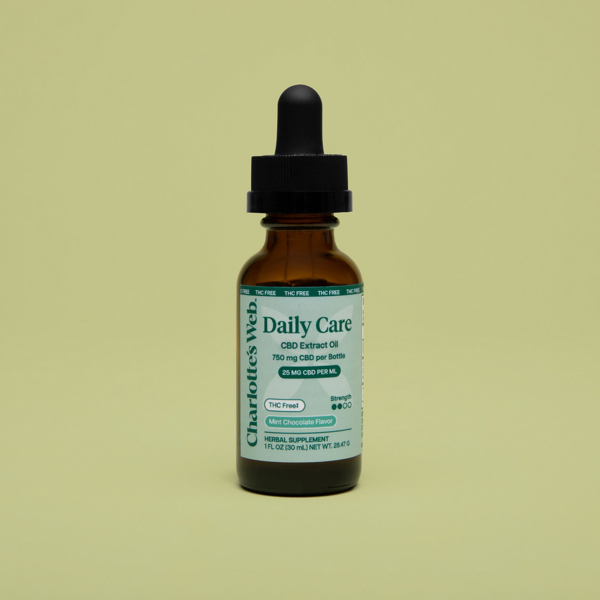 Bottle of Charlotte's Web Daily Care CBD Extract Oil on a beige background