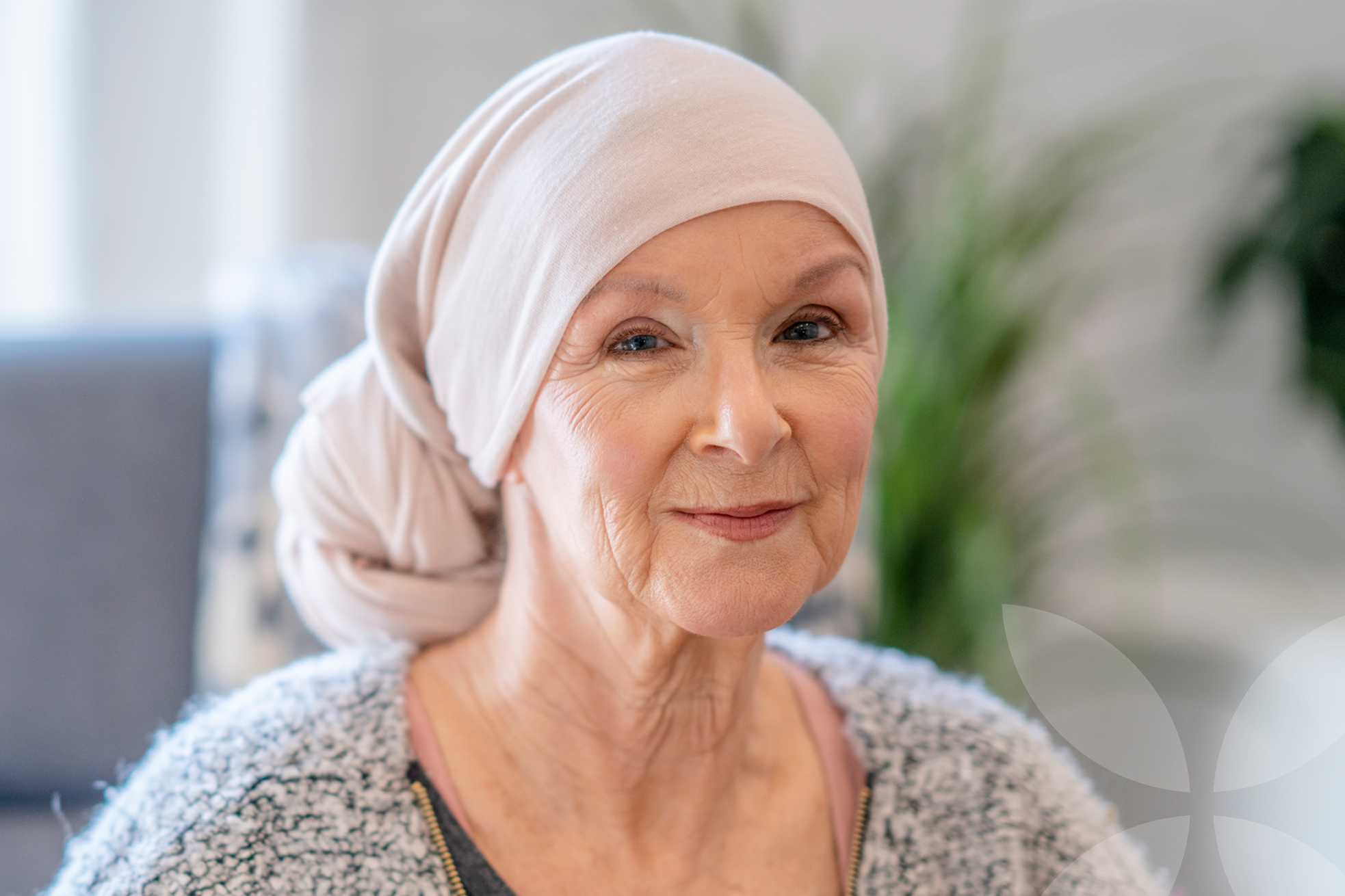 Woman wearing a beige headscarf in an indoor setting